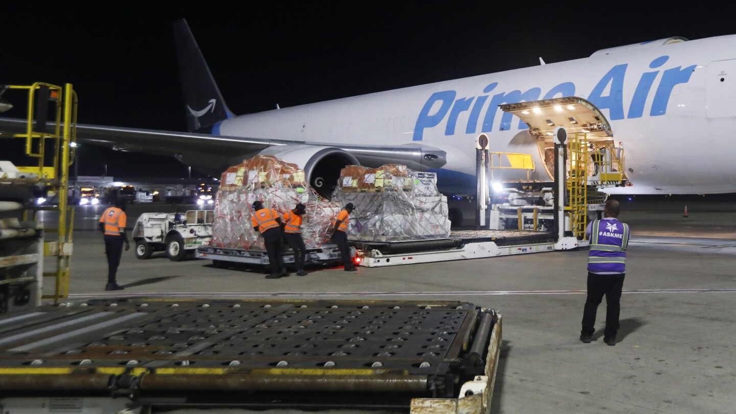 Cargo being loaded onto Prime Air plane at night