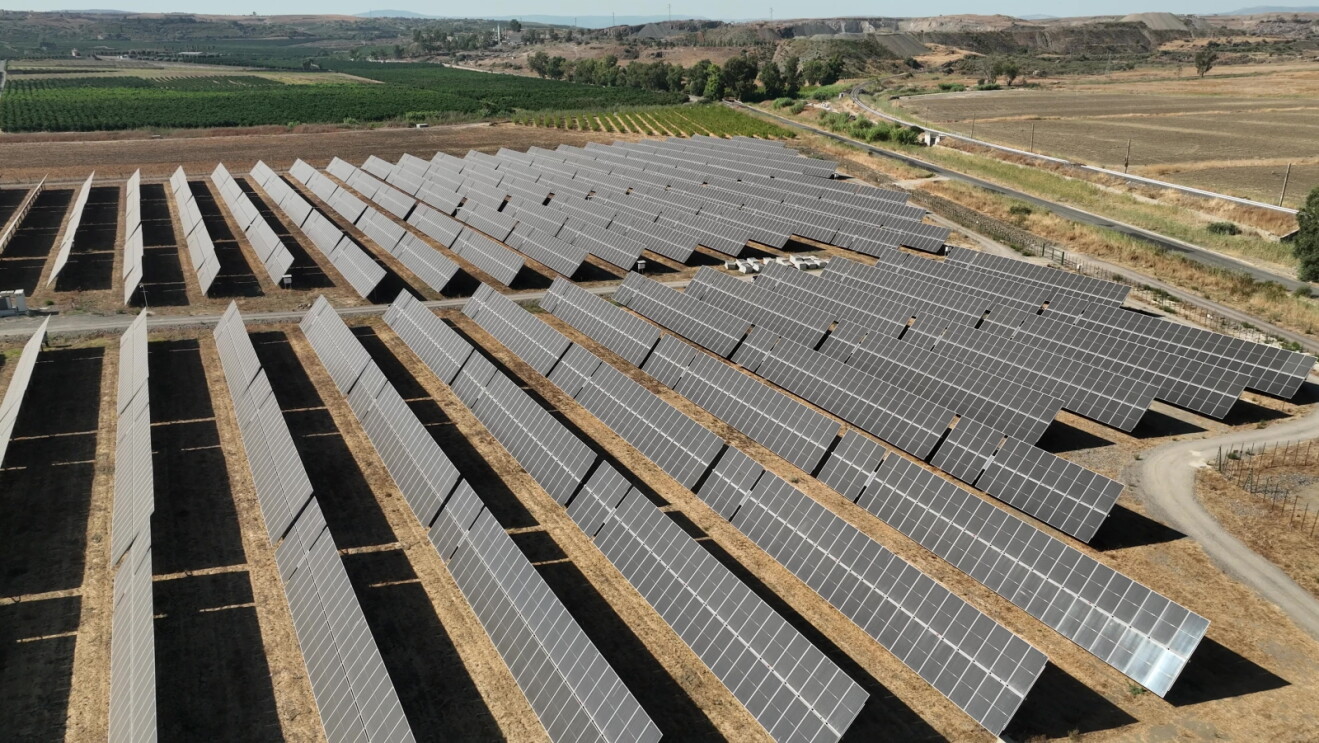 Solar panels in a countryside setting surrounded by fields