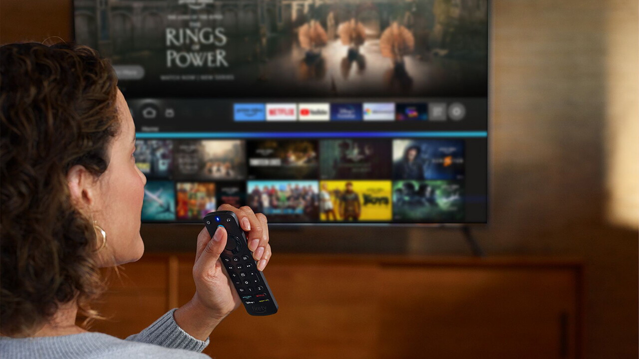 A woman watching TV with Fire TV stick