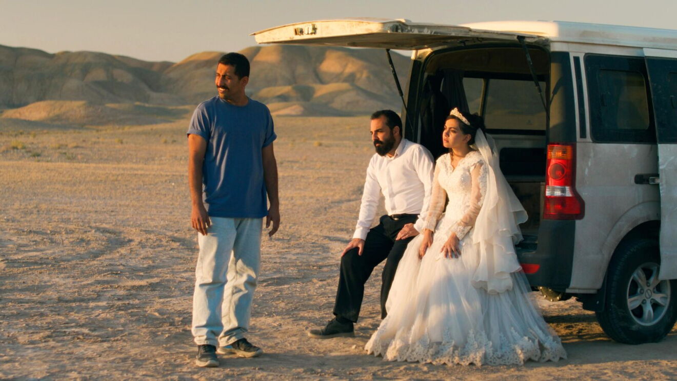Three people look in the distance