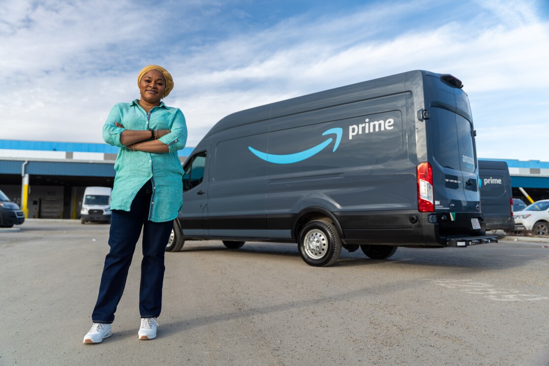 women standing in front of amazon van 