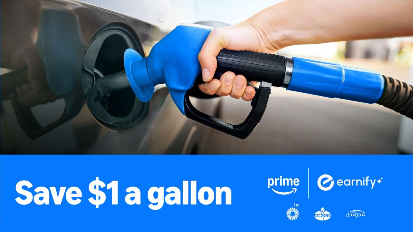 Hand holding blue gas pump nozzle with savings offer