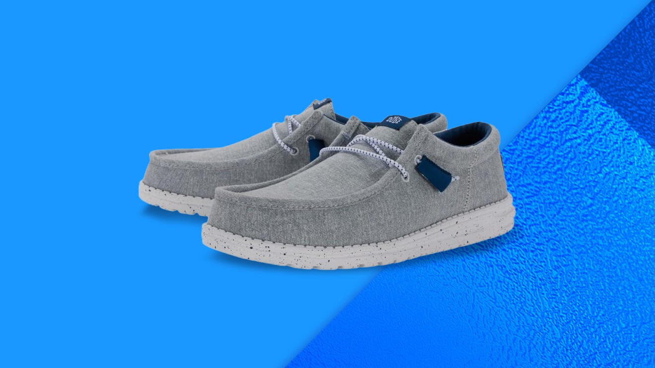 Gray canvas slip-on sneakers on blue background