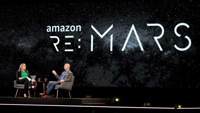 杰夫·贝佐斯和珍妮·淡水坐在re:MARS 2019舞台上的椅子上,在炉边聊天。