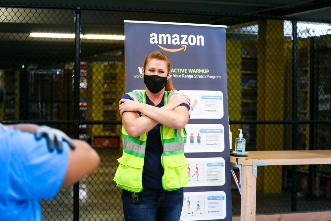 An image of an Amazon employee in a fulfillment center demonstrating how WorkingWell works.