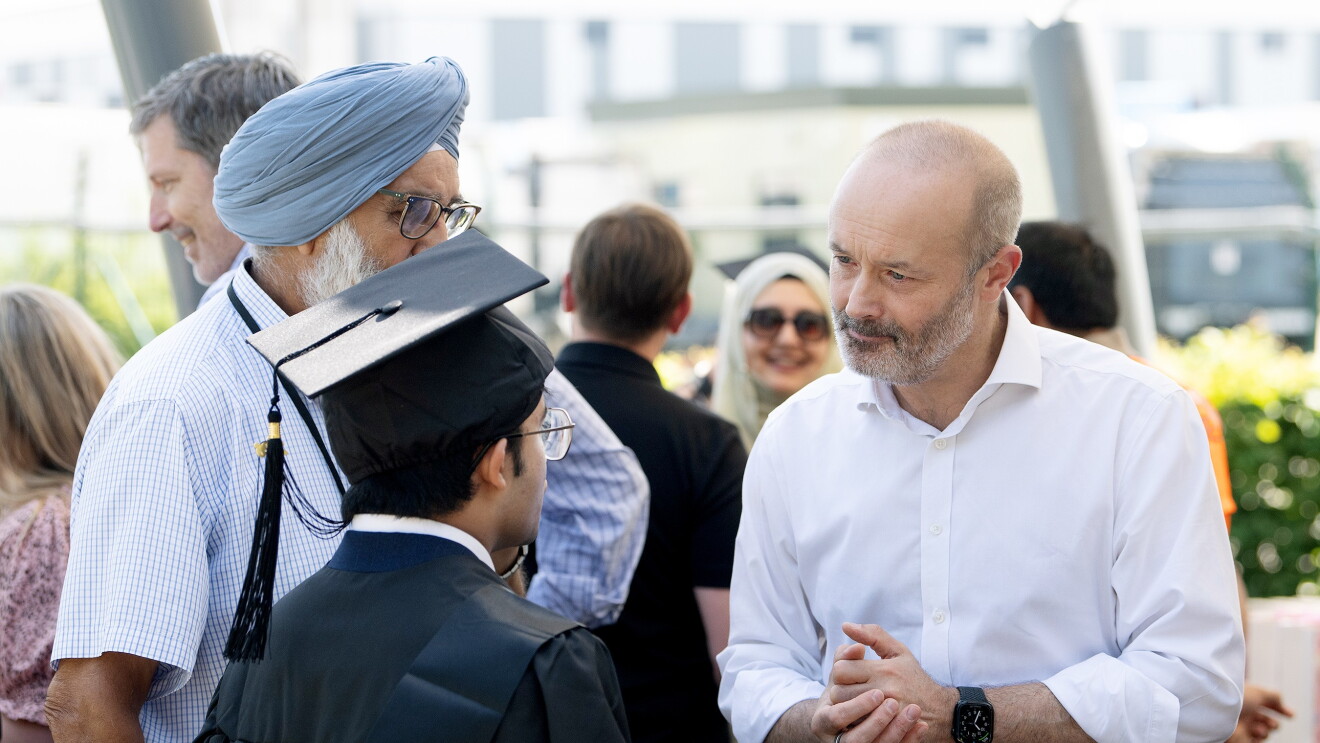 John Boumphrey talks to Supported Intern Tuhin at his 2026 graduation in Coventry