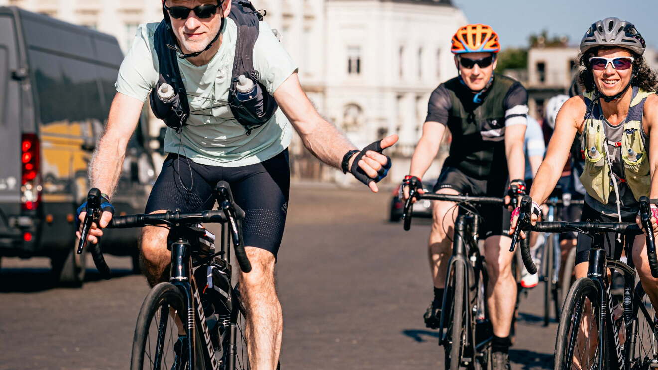 Andy Schleck cycling with Amazon employees. 