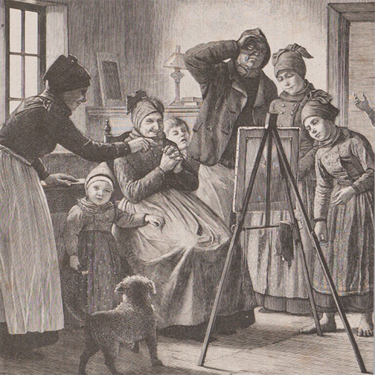 An etching shows a group of adults and children gathered around an easel holding an unseen painting. There is a small dog at the people's feet.