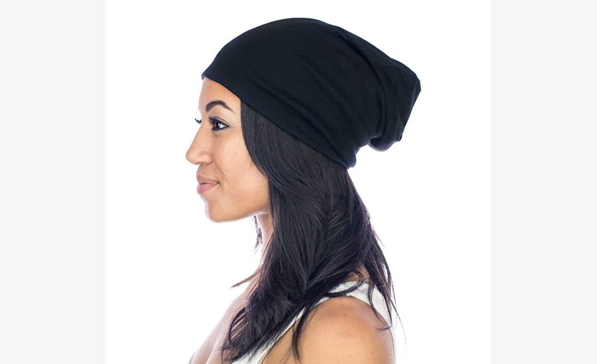 Woman wearing Grace Eleyae satin lined cap and showing her profile. 