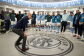 Pep Guardiola stands in the Man City dressing room, giving his players a team talk 