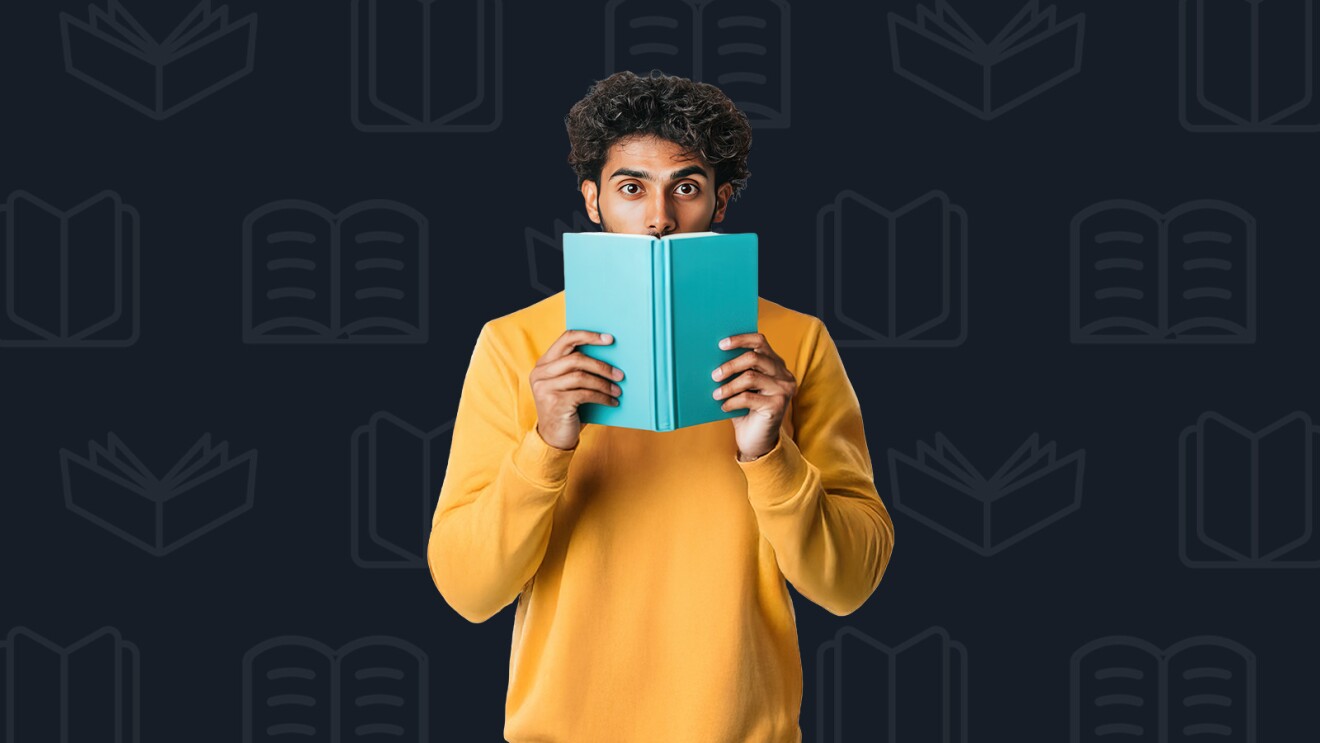 Person in yellow sweater hiding behind teal book