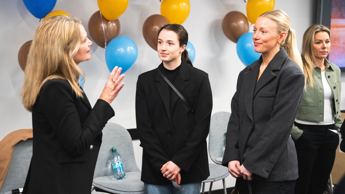 women speaking at event 