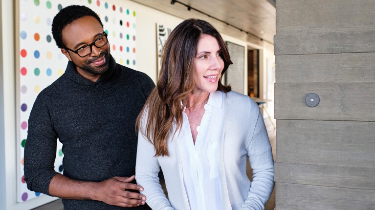 An image of two people interacting with Josh.ai, a home intelligence system with its own voice assistant.