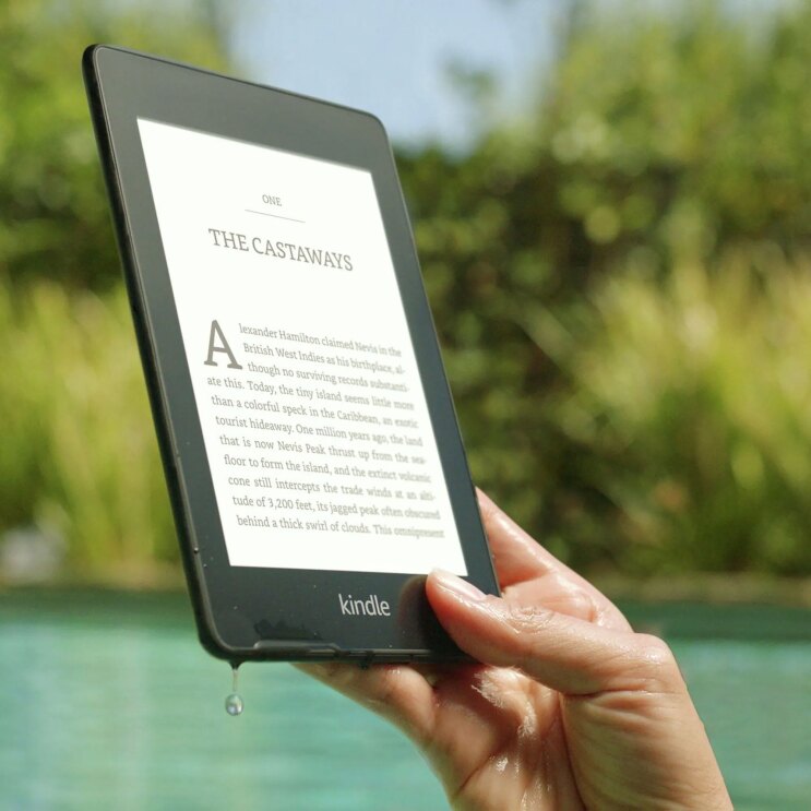 Waterproof Kindle Paperwhite being lifted out of a pool