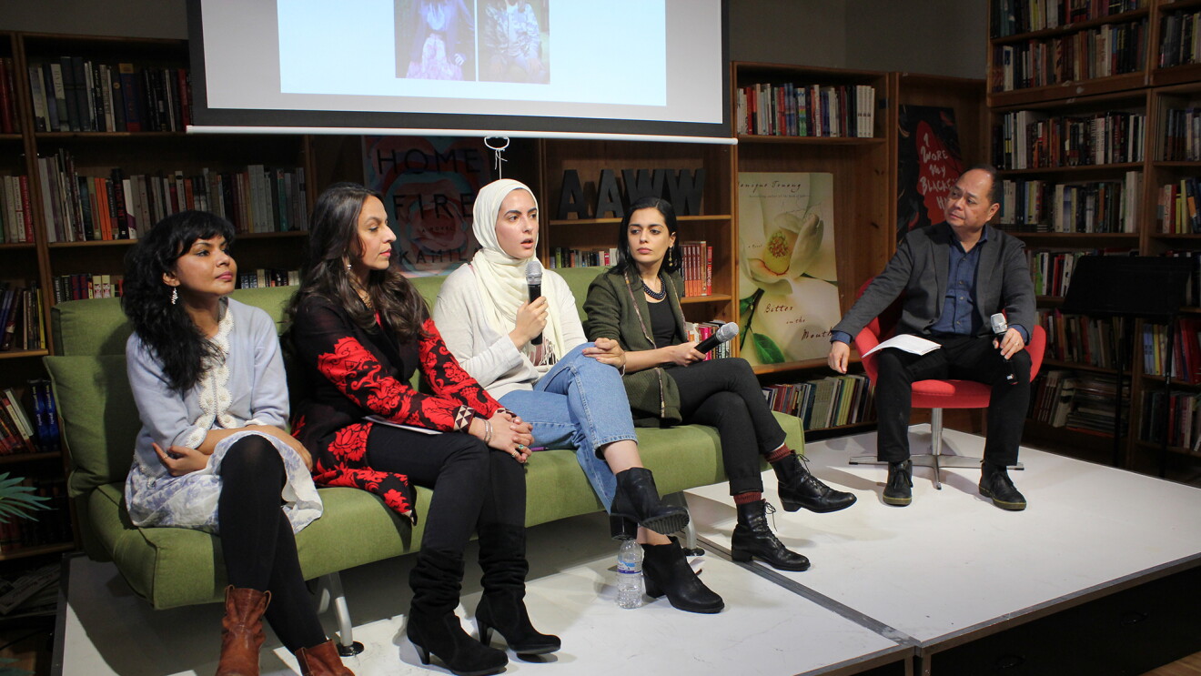 Five AAWW members, shown seated, four women sit side-by-side on a green sofa, a male sits to the right. 