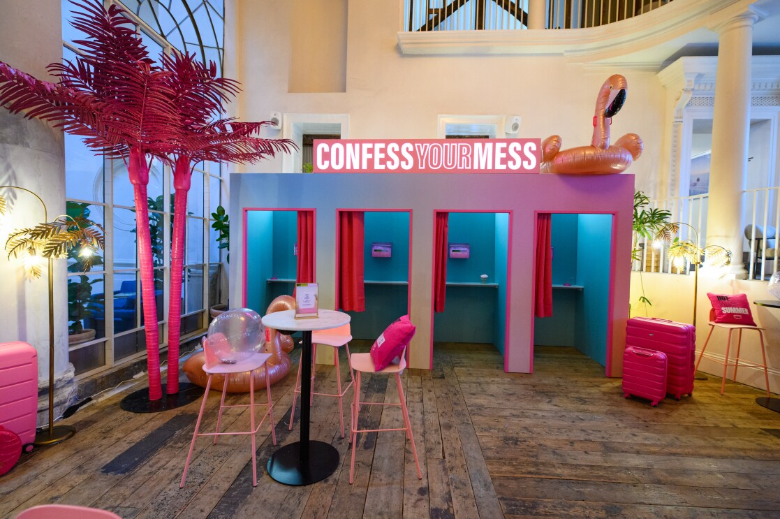 Pink and blue fake confession booths in a holiday bar