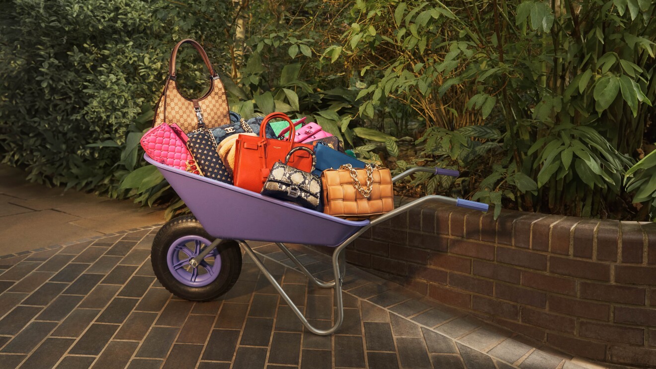 Colourful bags in a purple wheelbarrow in a green garden