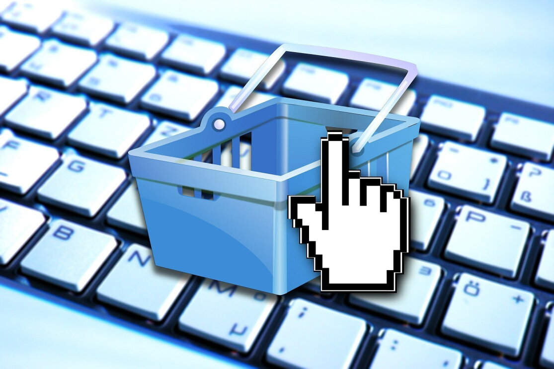 An image of a shopping cart on a keyboard depicting e-commerce