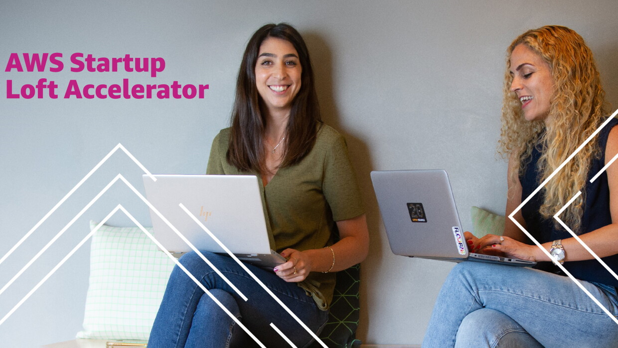 Picture of two ladies working on their laptops and smiling. Illustration of the AWS Startup Loft Accelerator