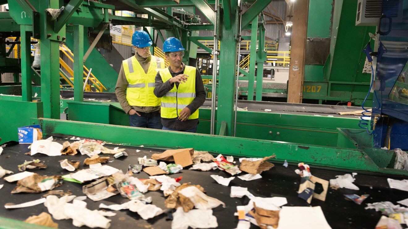 Areeb Malik shows Nick Ellis how the Glacier robot operates at a Materials Recovery Facility in San Francisco.