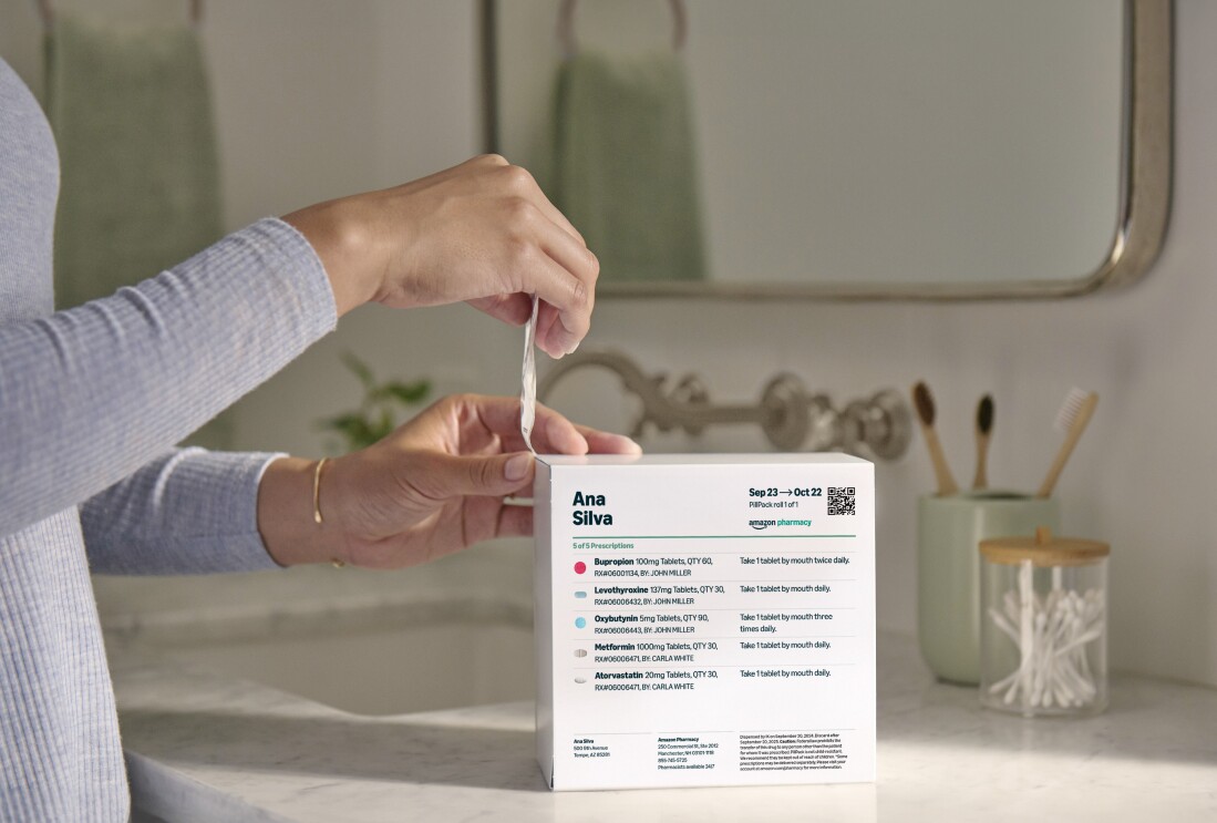 Person in a home setting using Amazon Pharmacy Pill Pack dispenser to open the correct medication