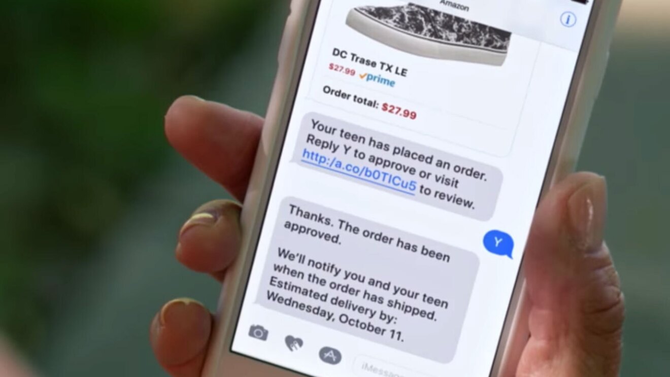 A customer's phone shows a push notification from Amazon indicating her order has been placed and approved. 