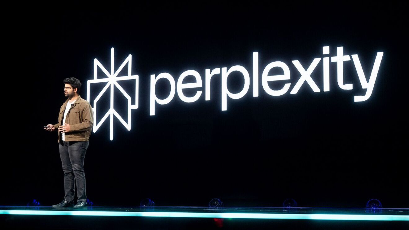 A photo of Aravind Srinivas CEO and co-founder of Perplexity AI, on stage at AWS re:Invent 2023.