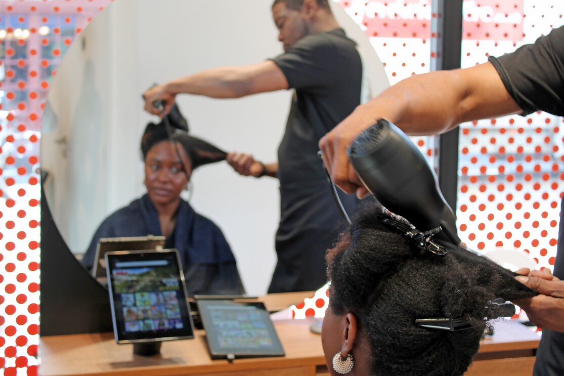 Stylist blow drying in Amazon Salon 