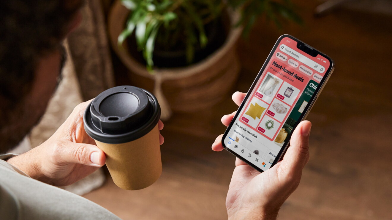 A person browsing 'Most-loved deals' on the Amazon shopping app while having a coffee
