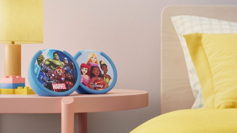 Echo Pop Kids smart speakers on a nightstand—Marvel and Disney editions.