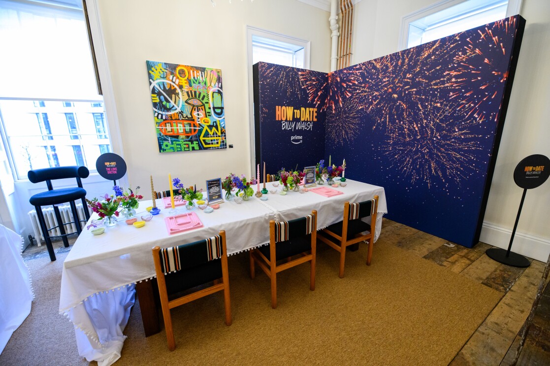 A room with tables and chairs filled with items to make friendship bracelets