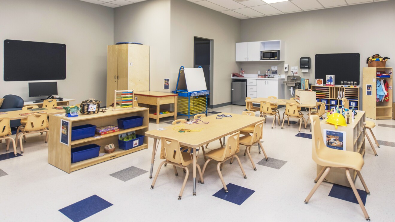 A photo of a Celebree School classroom, which includes workstations, cubbies, a small kitchen, and craft area.