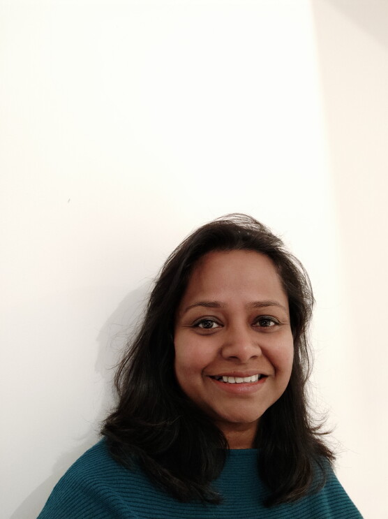 Headshot of Ramani Thangarasah-Halliwell, Customer Engagement Manager, AWS, she is smiling and looking at the camera. 