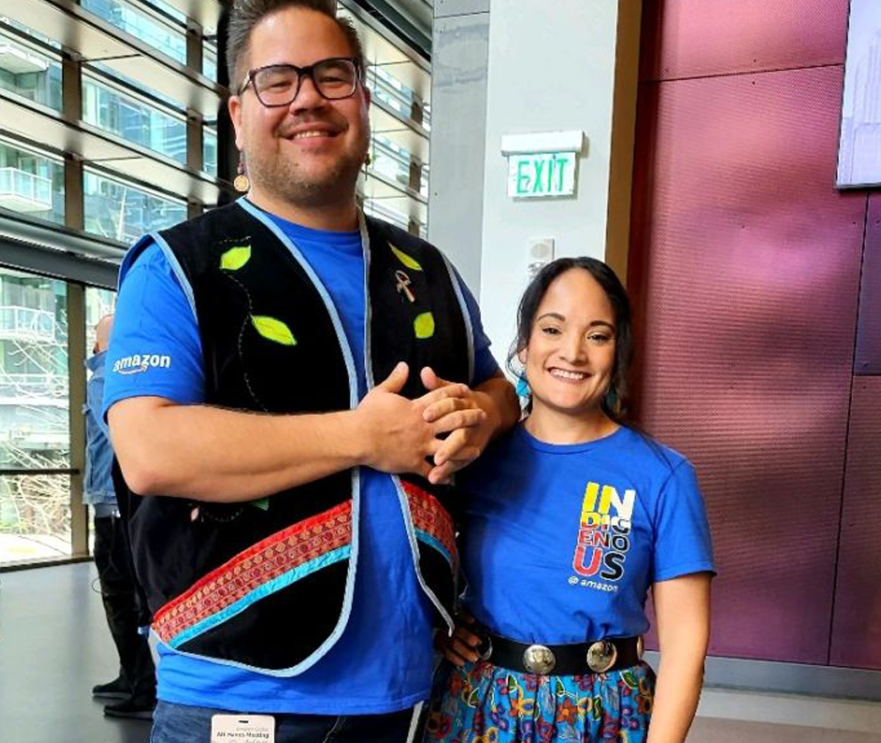 Fawn Sanchez and a colleague smiling at the camera in an Amazon building. 