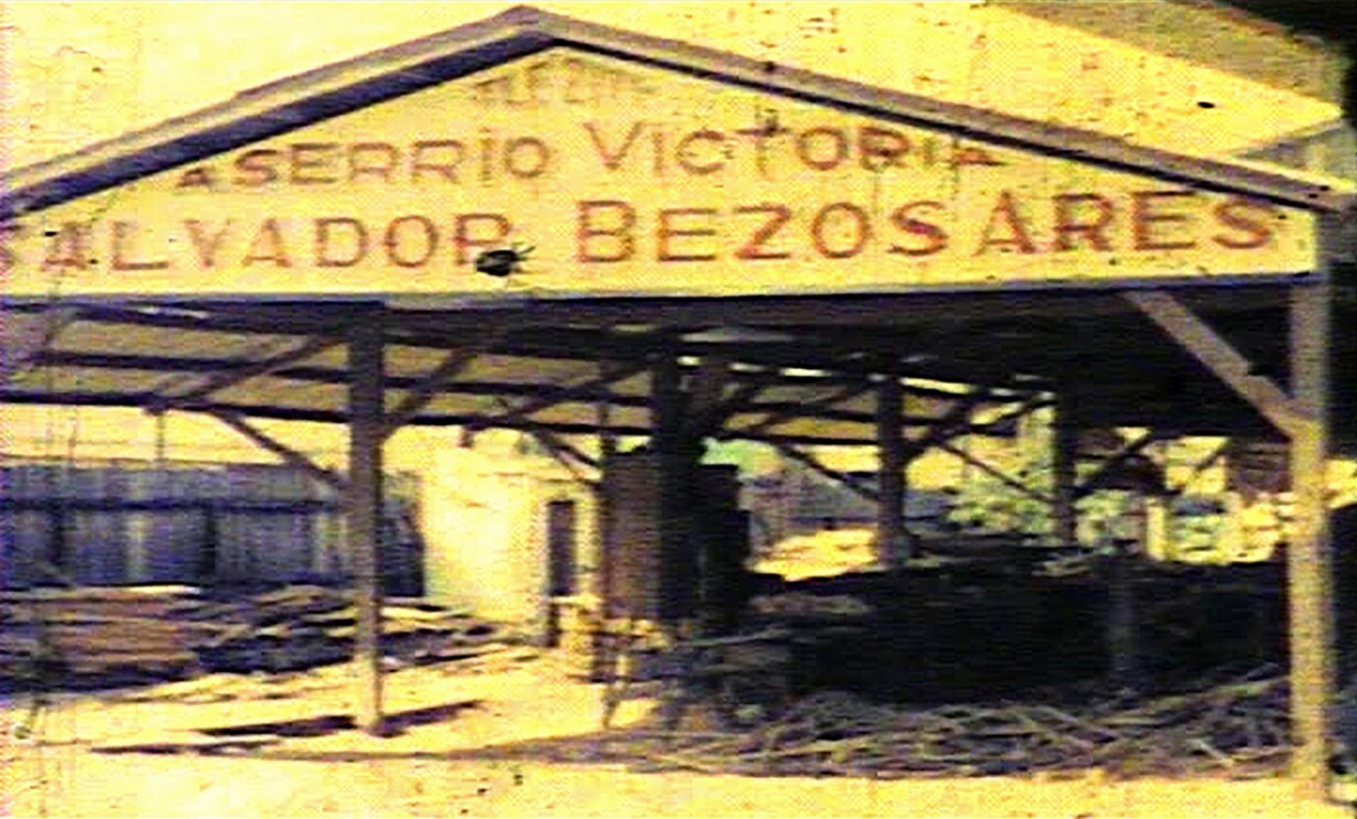 Vintage image of a lumber mill. The painted sign on the building includes the family name "Bezos."