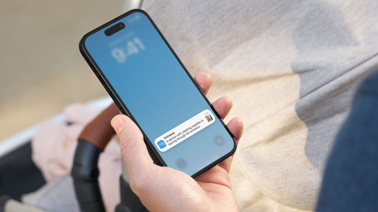 Hand holding smartphone displaying iOS message notification