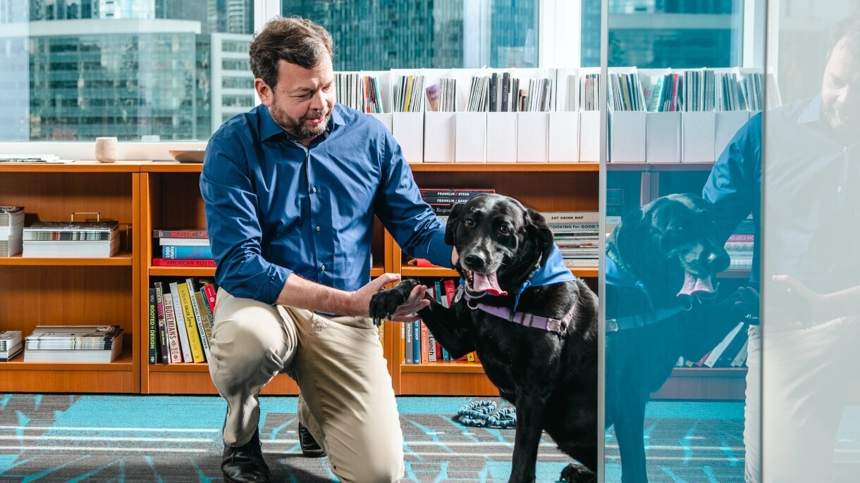 Chris and Sadie "shake" as they sit outside of Chris's office.