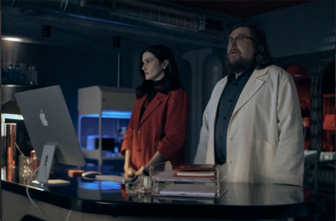 Rachel Weisz and Michael Chernus standing in a medical laboratory