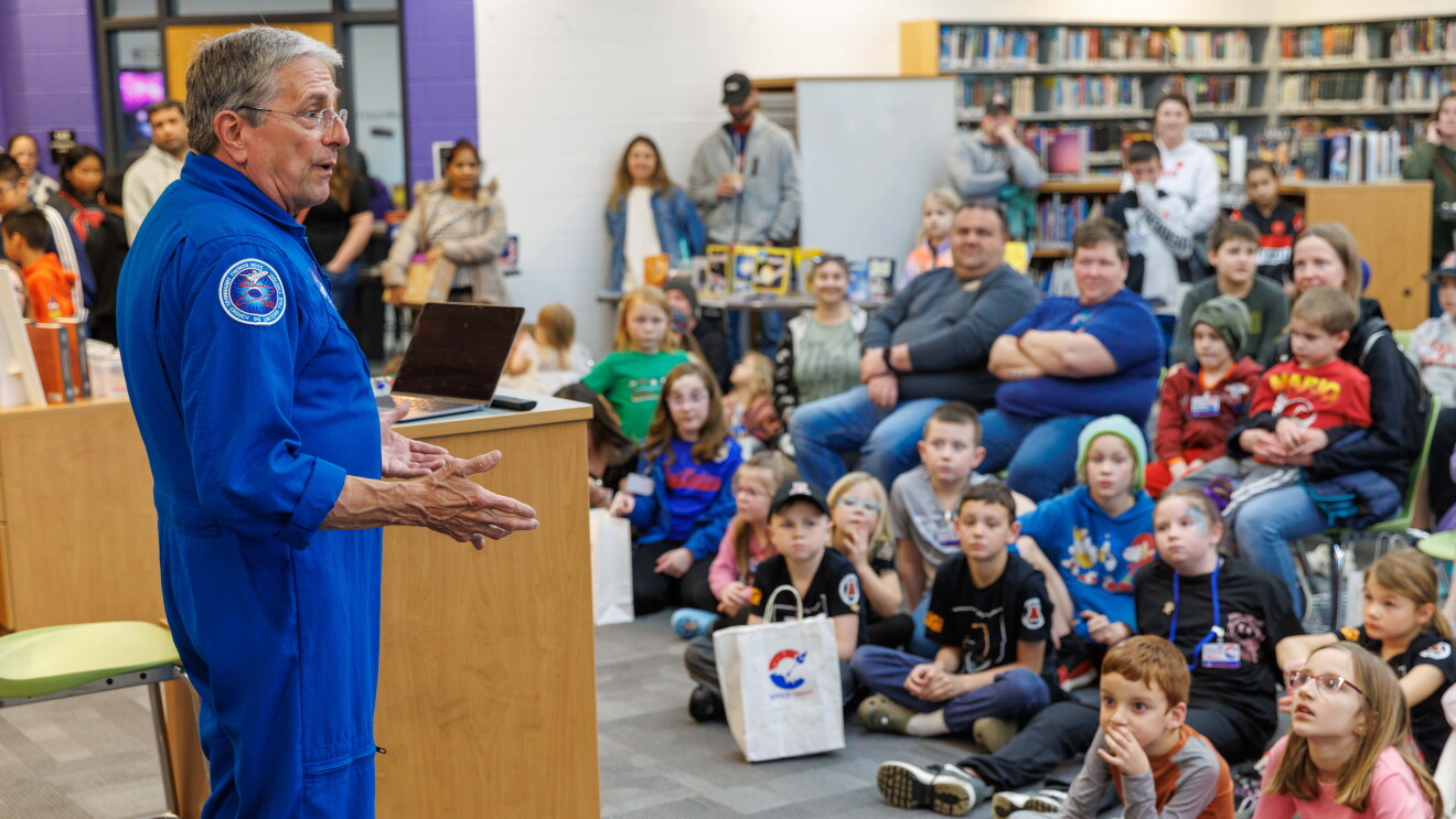 NASA speaker addresses crowd of children and adults
