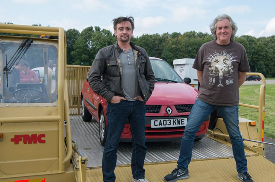 two men (Richard Hammond and James May) pose in front of a red car