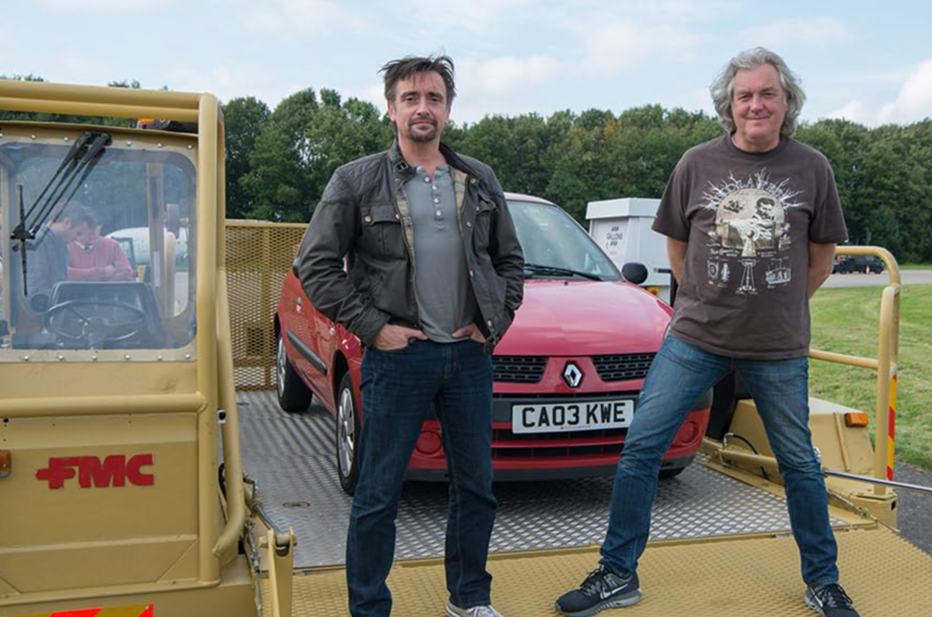 two men (Richard Hammond and James May) pose in front of a red car 