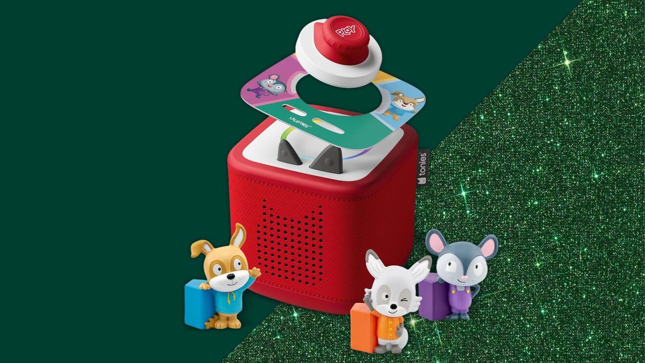 Toniebox audio player with cartoon animal figurines on glittery background