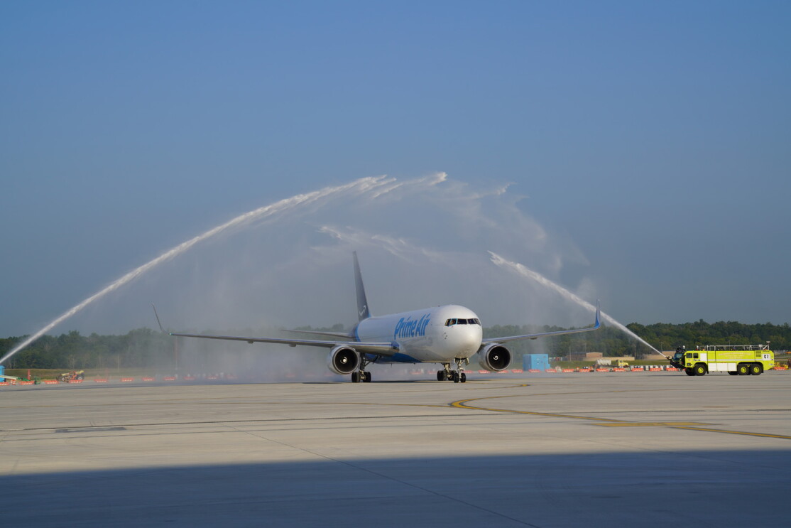 An image of a plane on the runway at the new Air Hub. The plane is being sprayed down with a fluid.