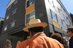 Crowd gathered in front of contemporary multi-story residential complex