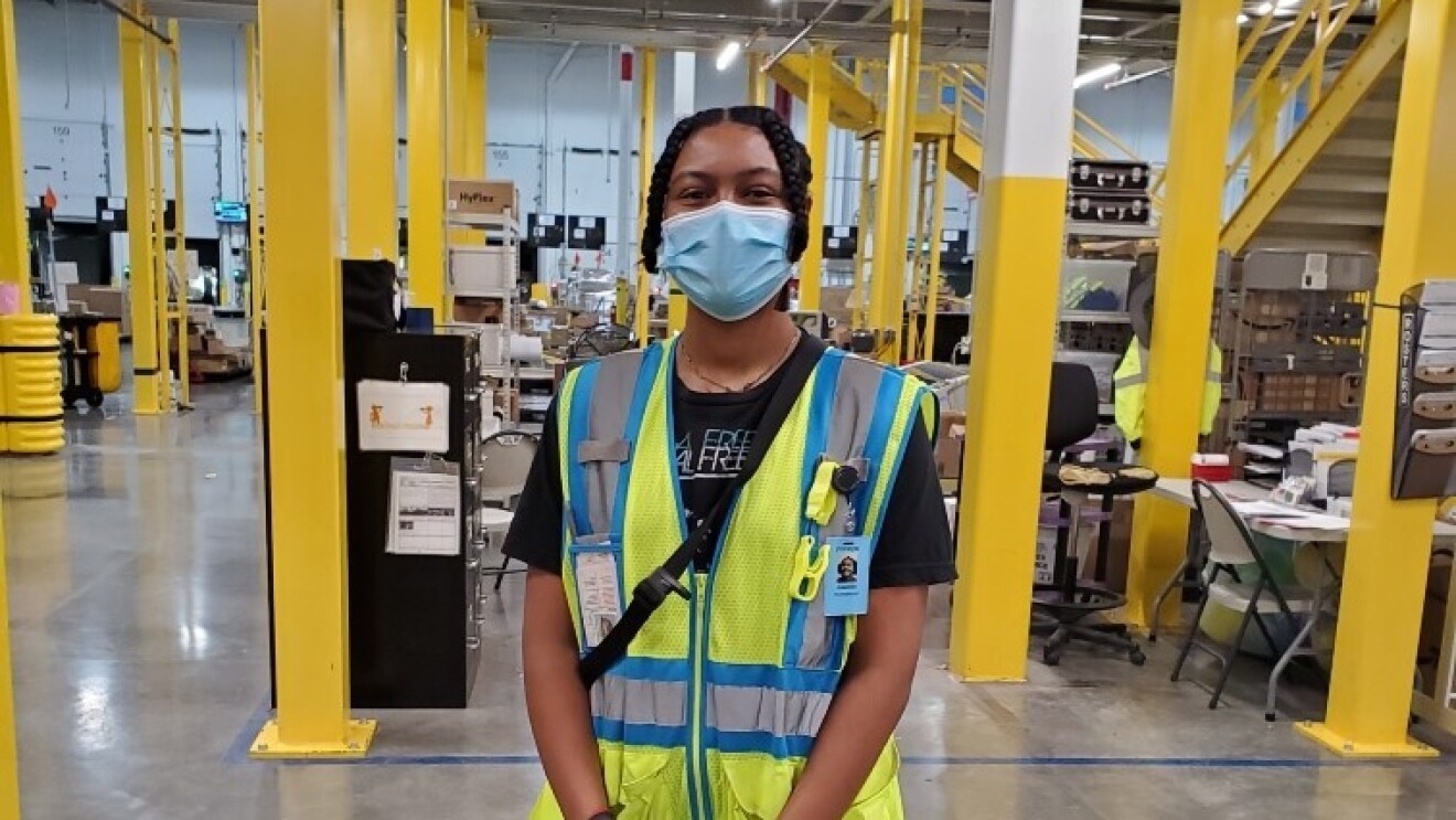 Amazon employees who work on the middle mile, posing for the camera at work