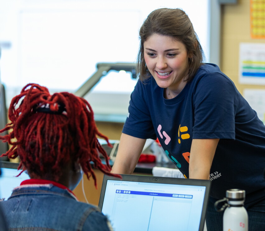 Amazon employee volunteers work on coding projects with students at Dunbar High School in Washington, DC to celebrate Amazon Future Engineer's 2,000 high schools milestone.