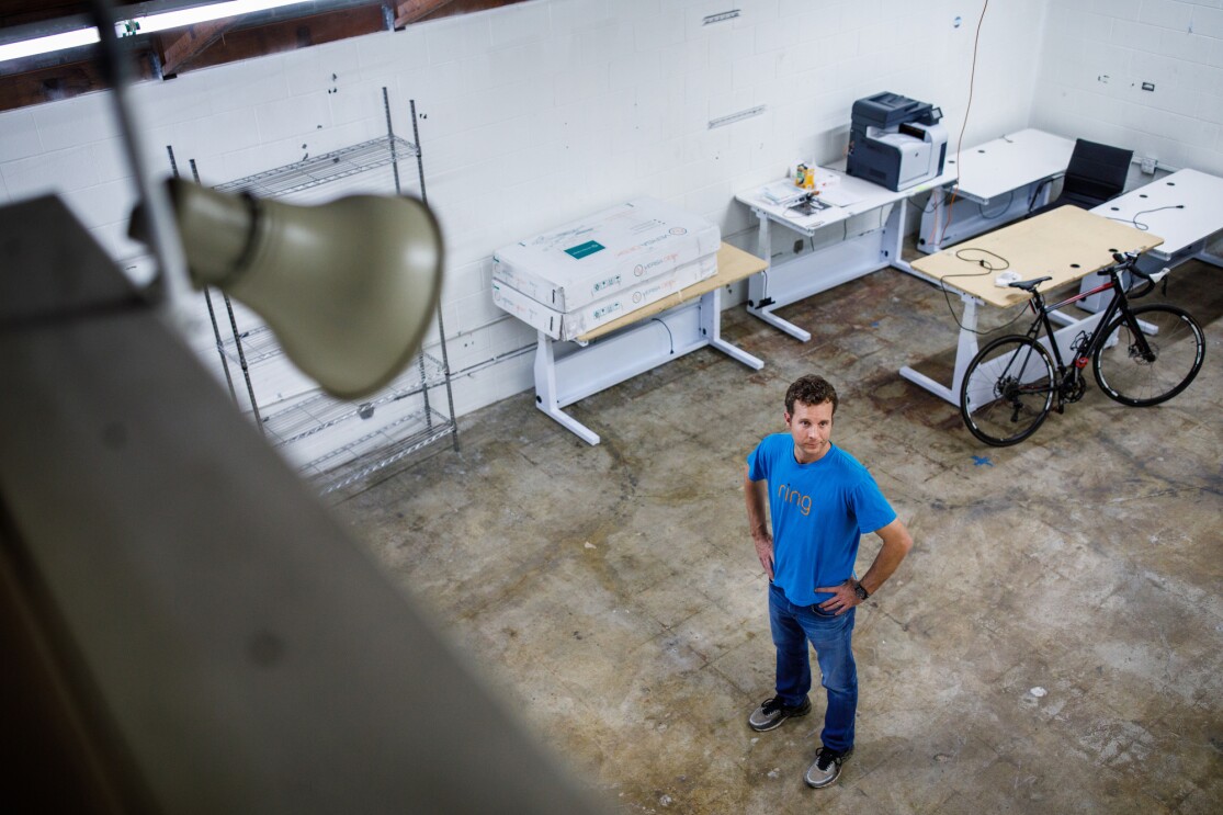 Jamie Siminoff, founder of Ring, stands in a workspace with concrete floors at Ring headquarters in Santa Monica, CA. 