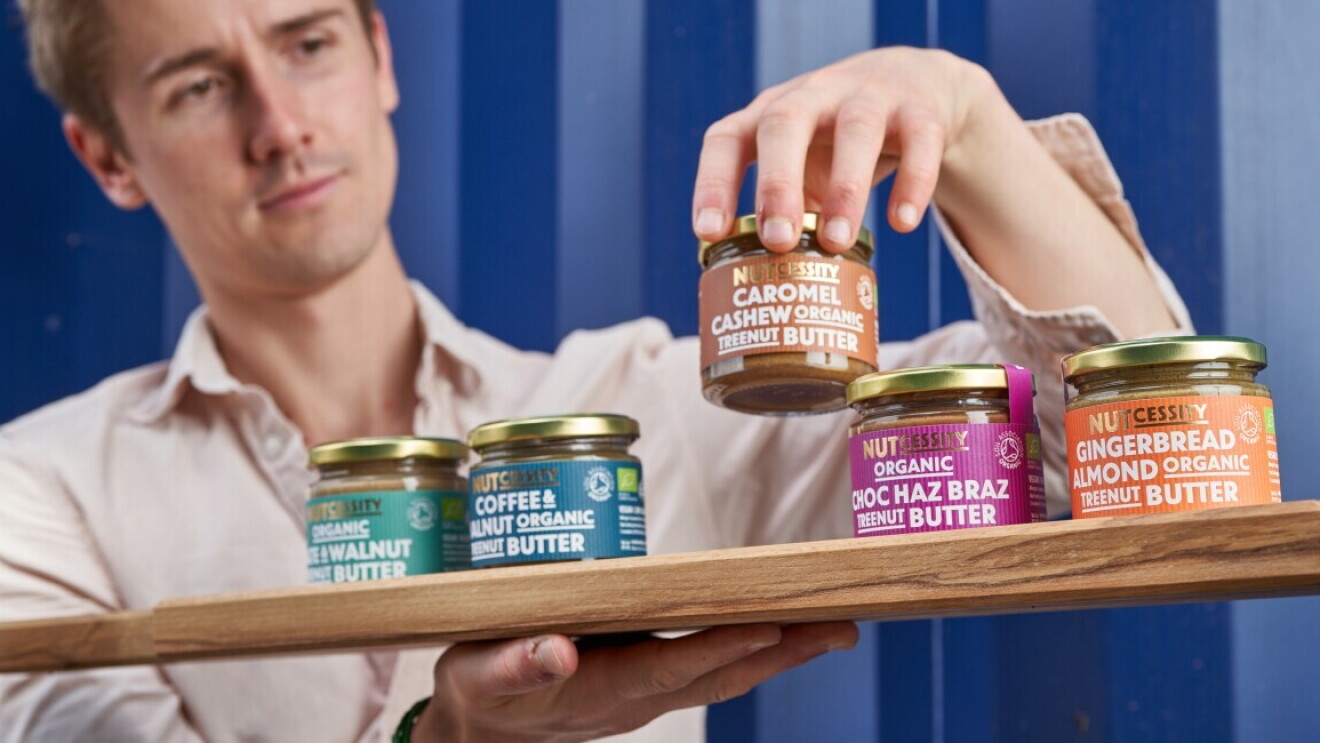 Nutcessity Founder with products on wooden chopping board