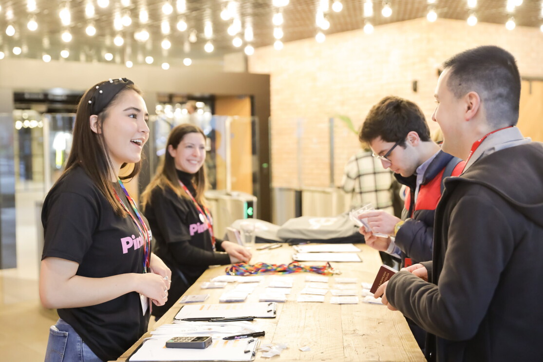 Visitors receiving entry passes for the LGBT Leaders in Stem event at the reception area of Amazon's London head office. 