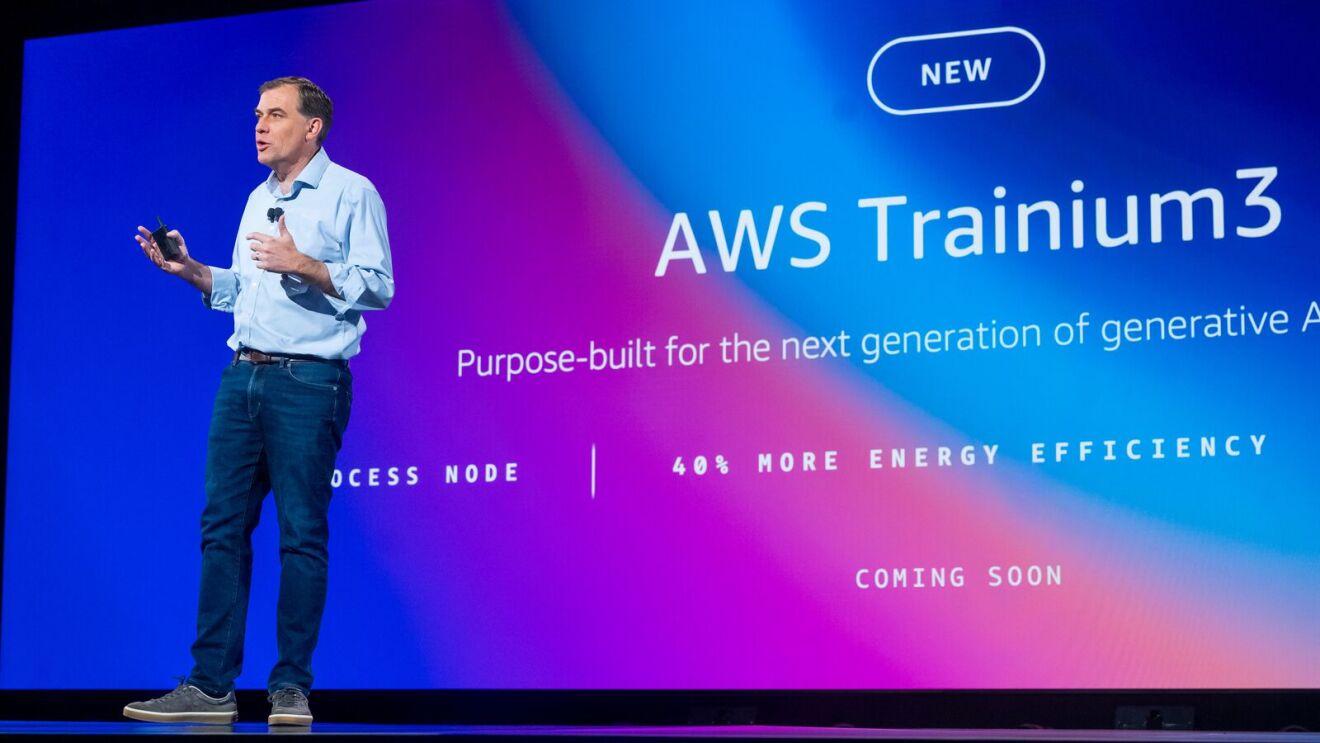 Matt Garman, AWS CEO on stage at re:Invent 2024. The screen in the background states, "AWS Trainium3 Purpose-built for the next generation of generative AI".